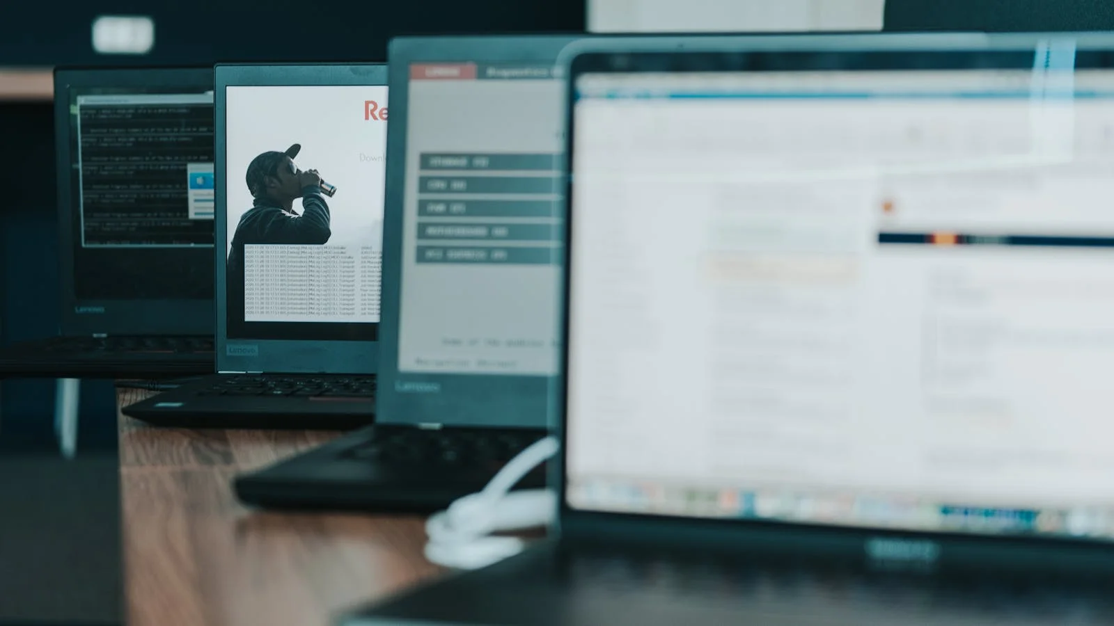 Row of laptops in an office — device fleet management